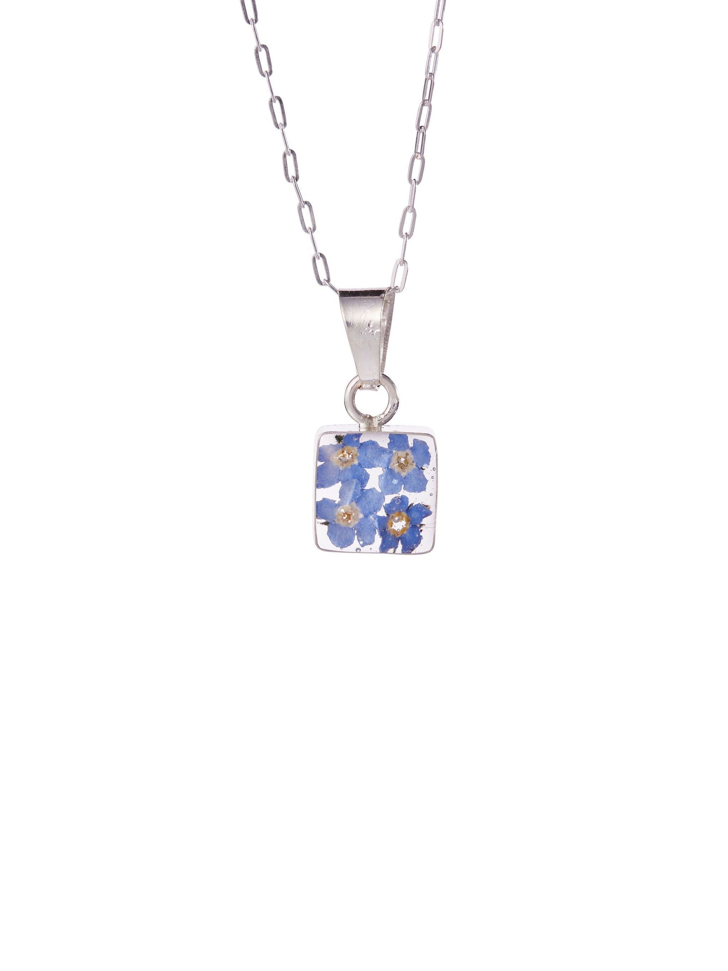 A sterling silver necklace with a small square pendant containing real forget me not flowers preserved in clear resin, suspended on a 16” chain.