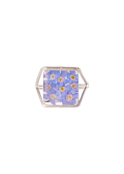 A Sterling Silver Square Ring with a medallion of forget me not flowers in blue and white colors.