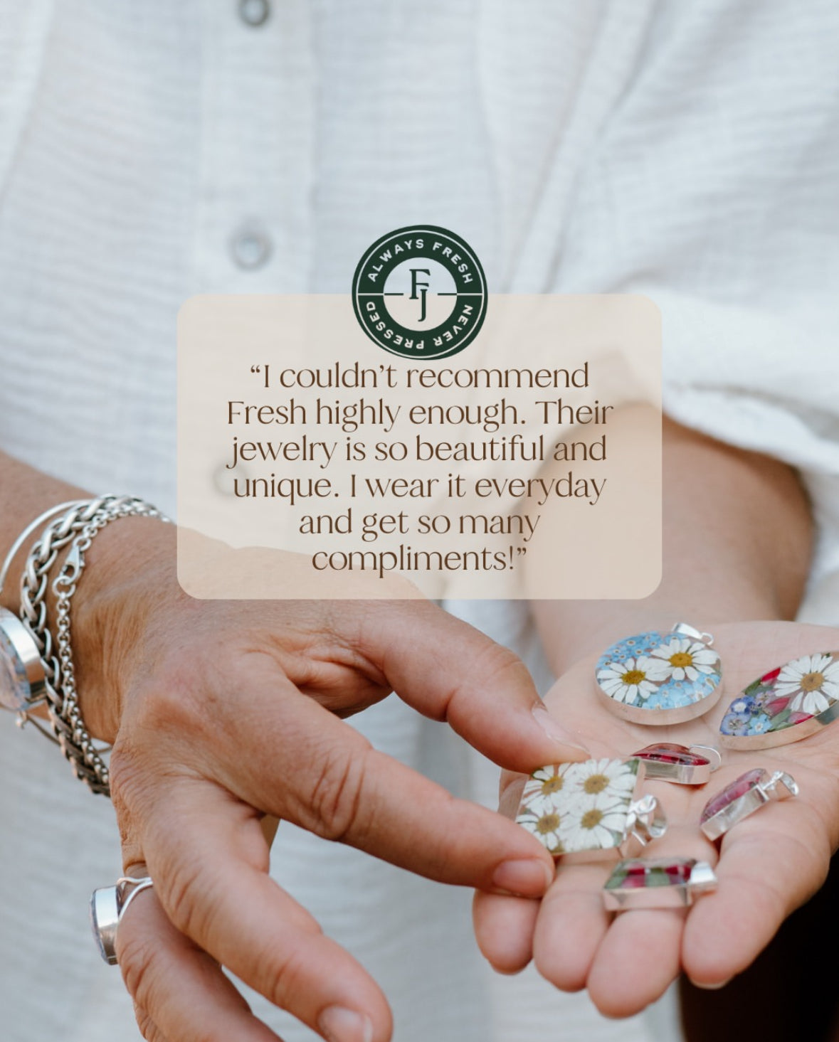 Person holding floral pendants with a quote and brand logo overlay